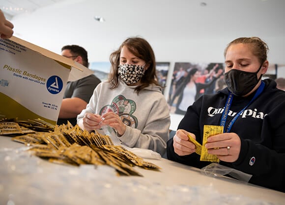 Students put bandages in a box.