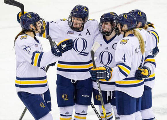 Women's ice hockey team in a huddle