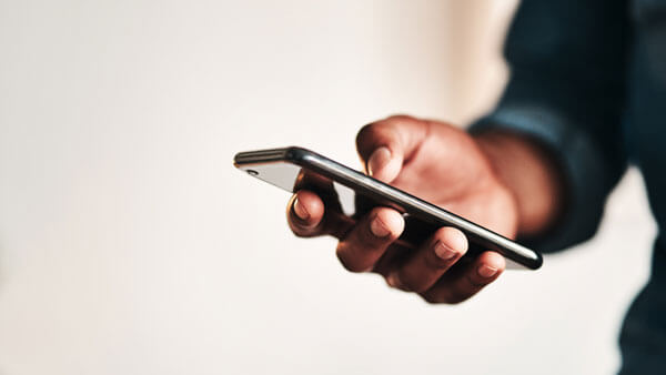 A person holds a smartphone in their hand