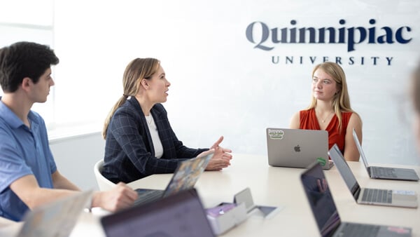 Faculty and students having a meeting in a conference room