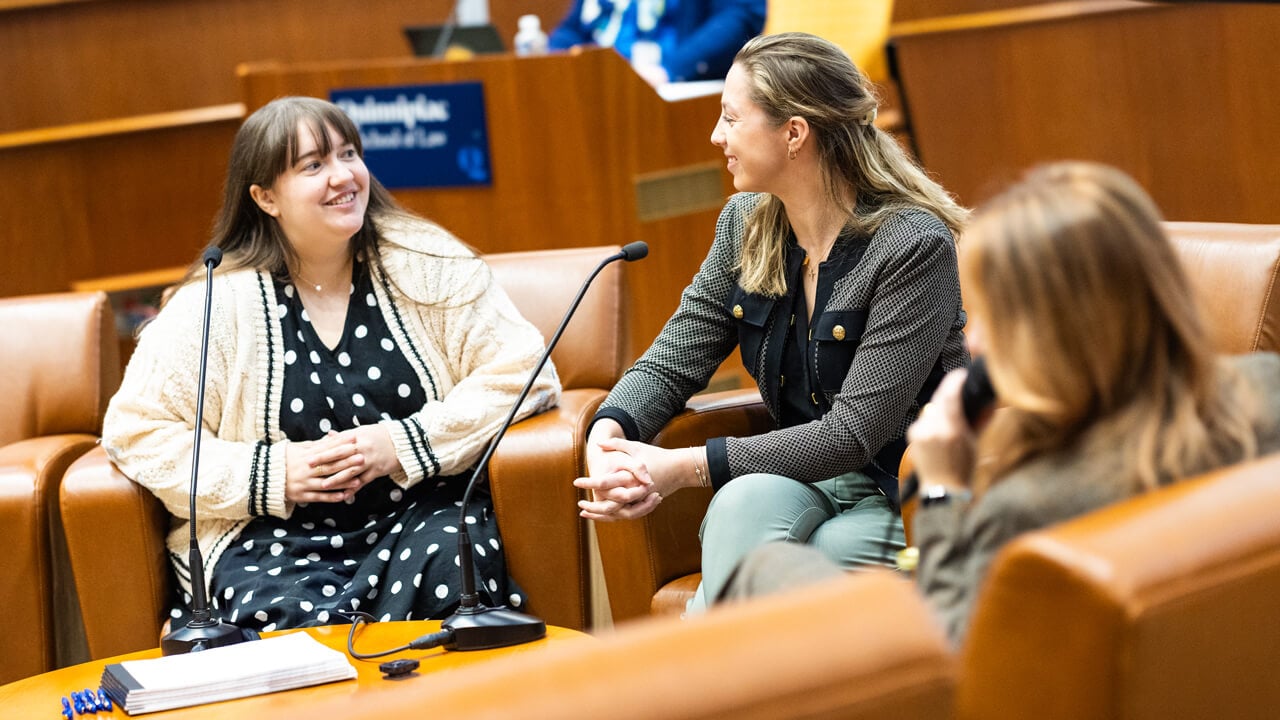 Individuals sitting and speaking