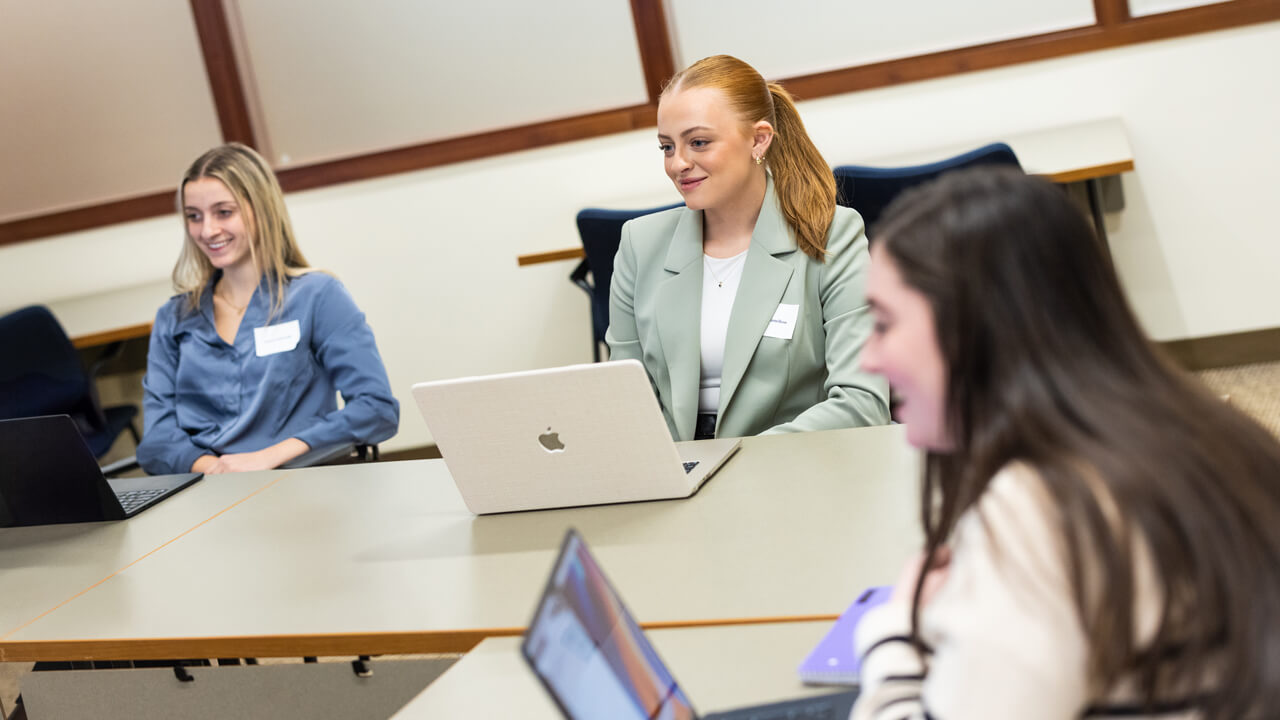 Two people sitting with laptops