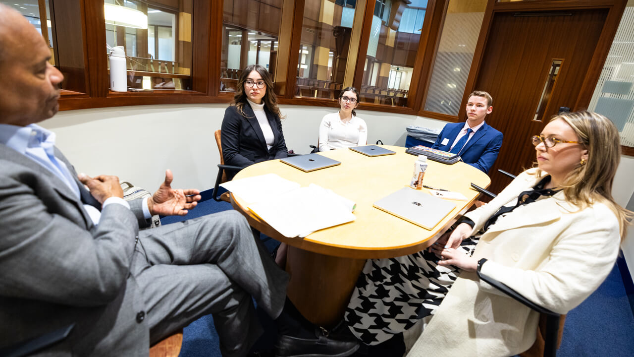 Group of people sitting around a table and talking