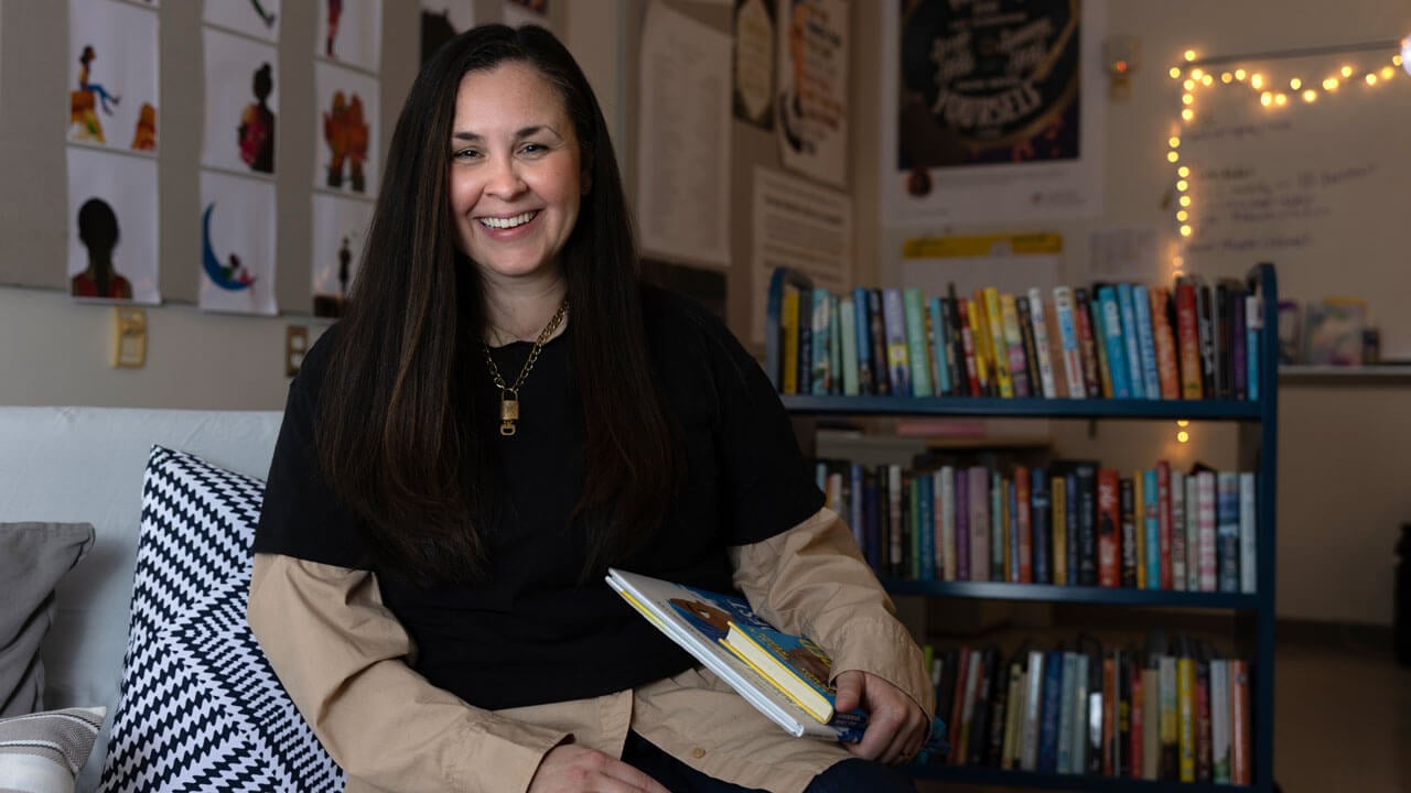 Kara Breen poses with a selection of books from her new anti-racism literature course