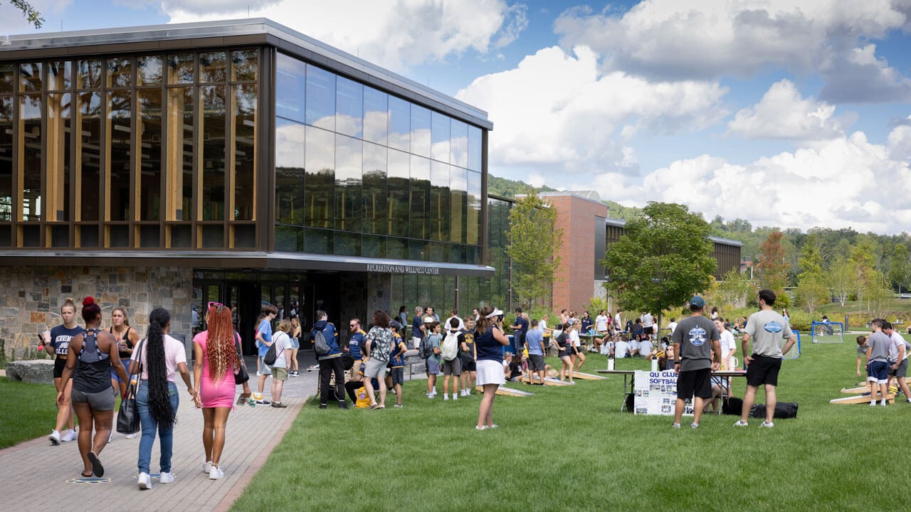 Groups of students walk outside RecWell.