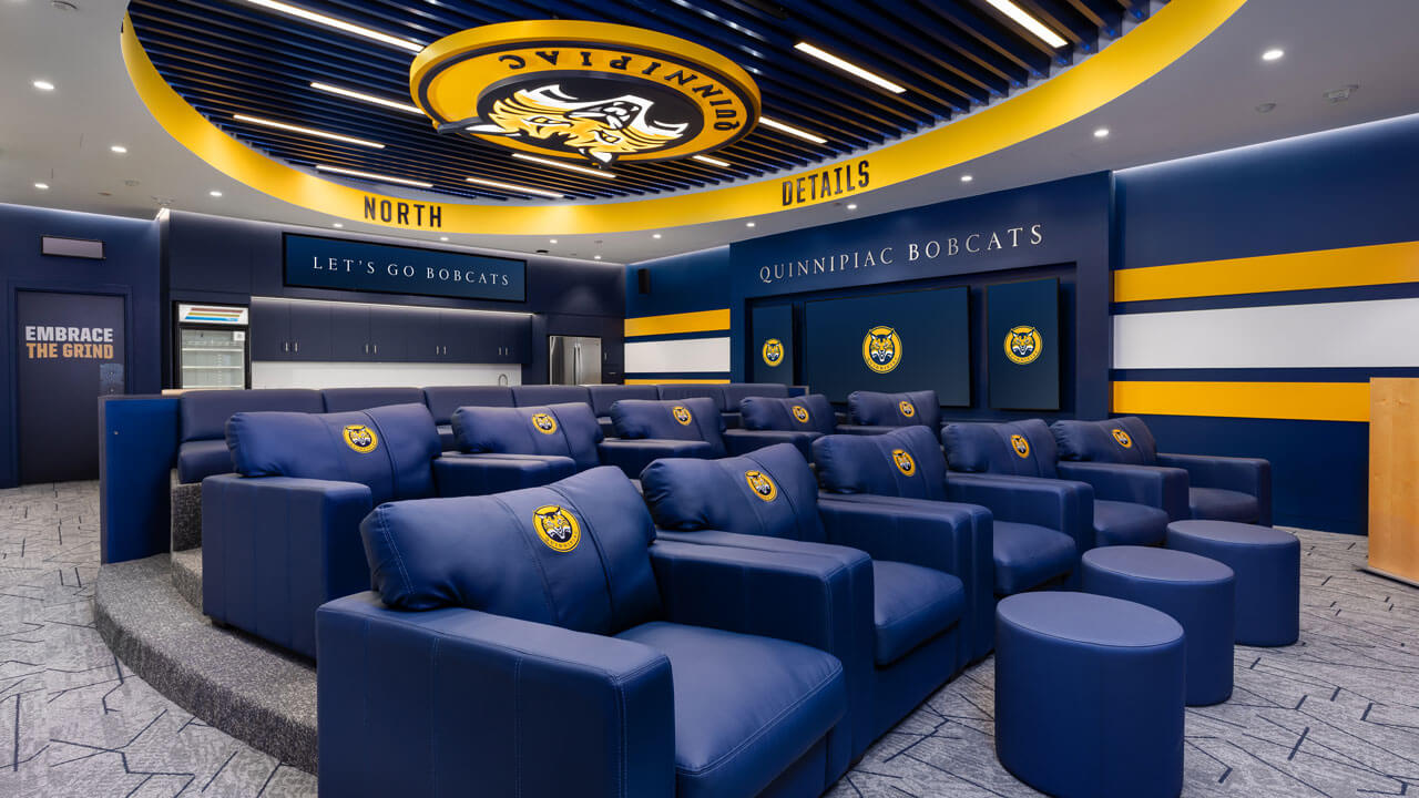 Wide shot of men's ice hockey locker room.