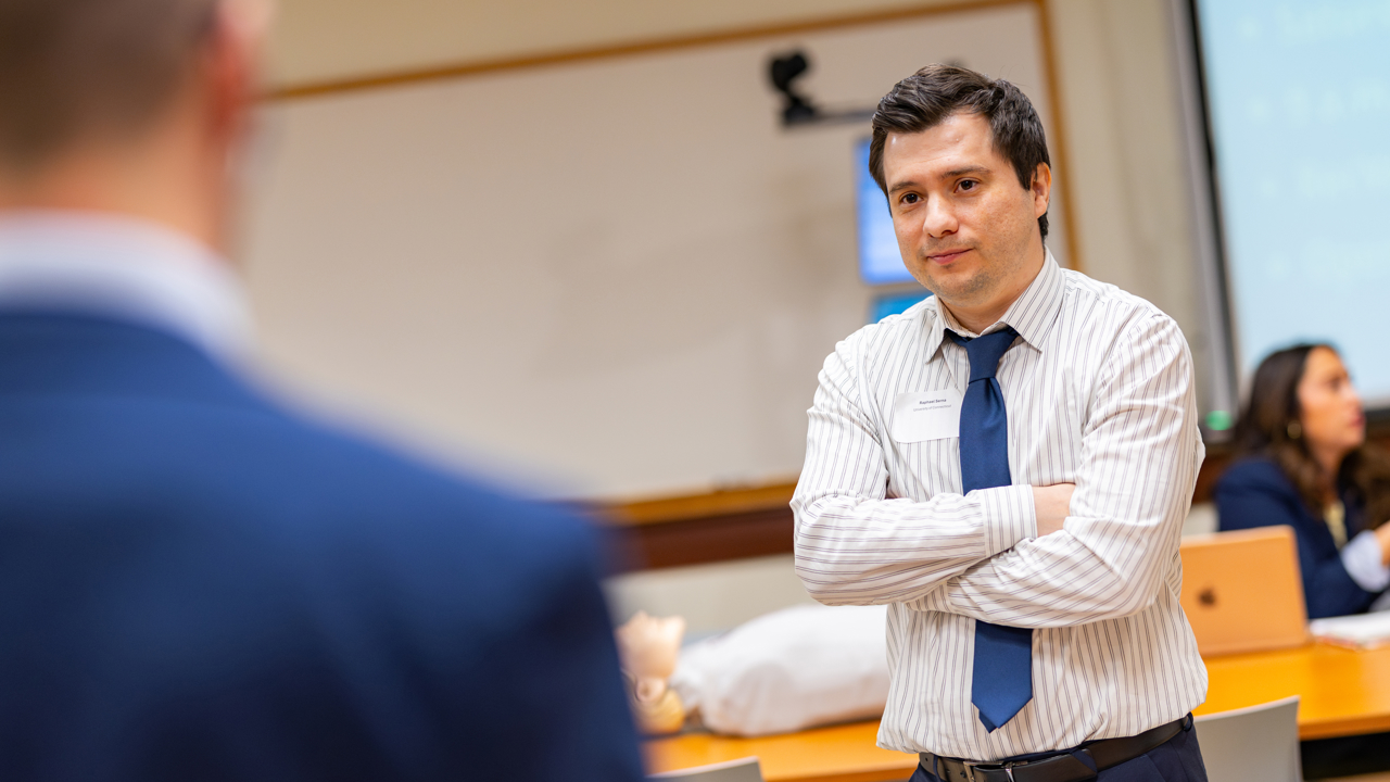 Student listens with their arms crossed.