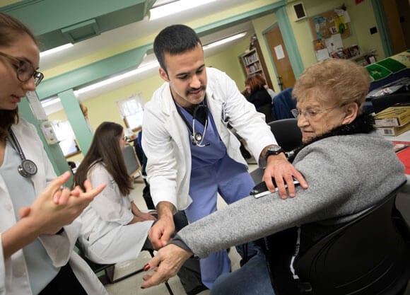 Physician assistant students volunteer with community members during a health fair