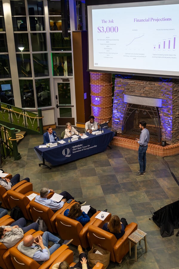 Students watch their peers participating in the pitch competition.