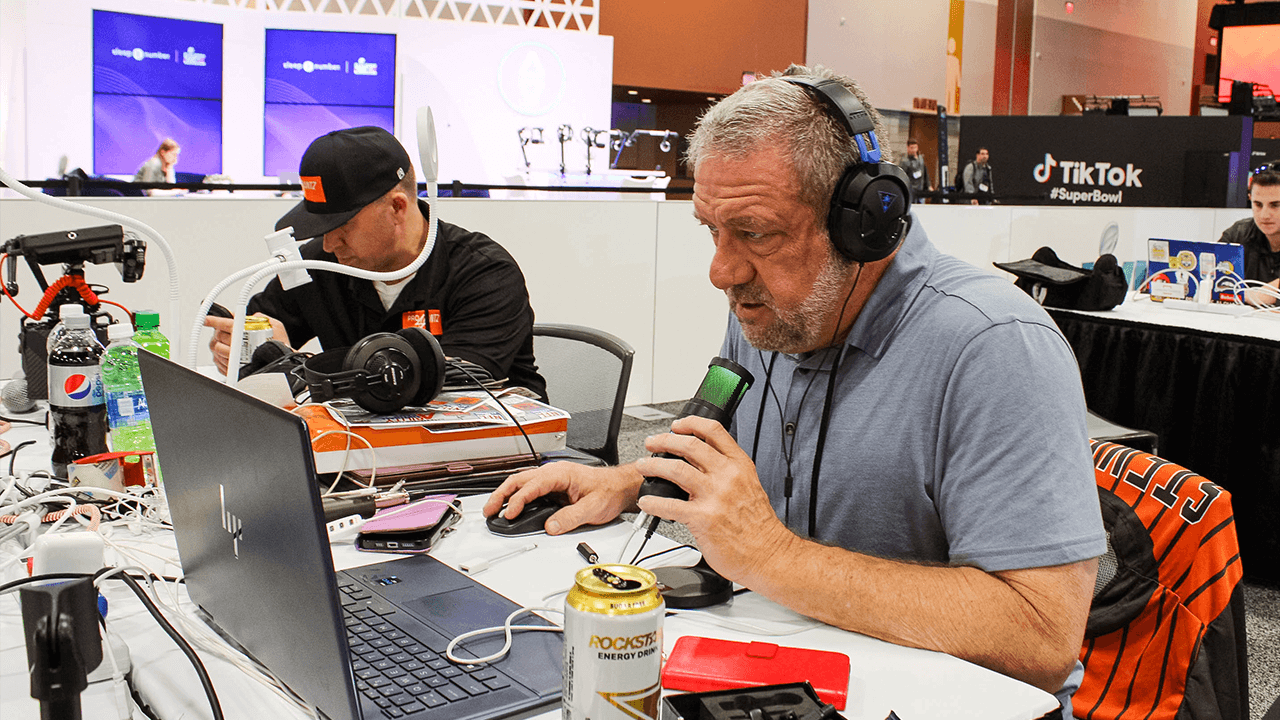 Professional in Residence Dave Stevens works on his computer at Radio Row.