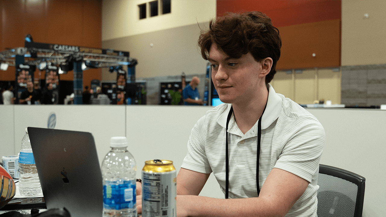 Ability Media reporter Aiden Barrett works on his computer at Radio Row.