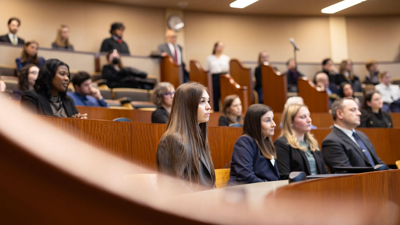 A courtroom full of students and observers facing the front of the room