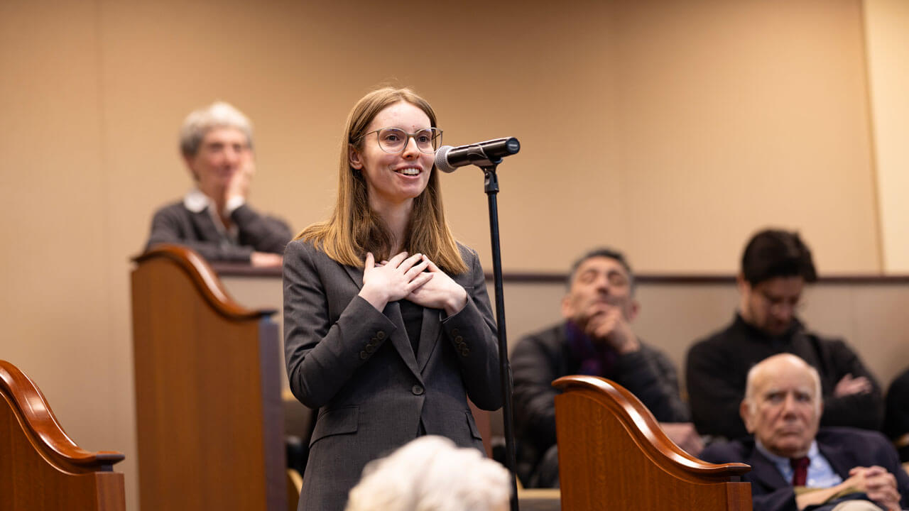 Audience member talks into a microphone
