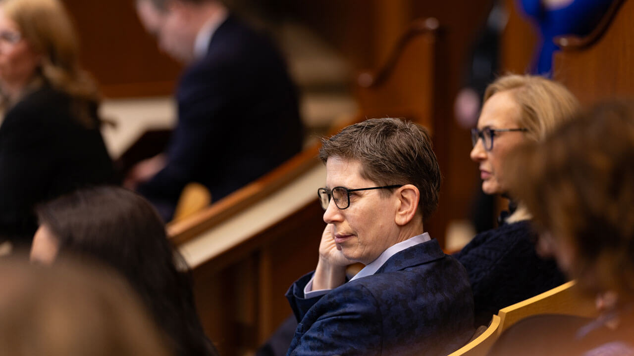Audience members looking up towards the front of the court room