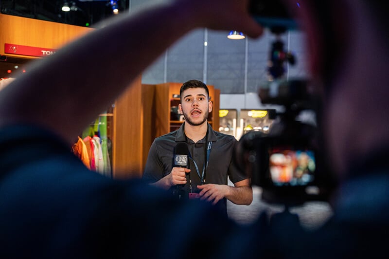 Santino Maione speaks in front of a camera in the NFL locker room