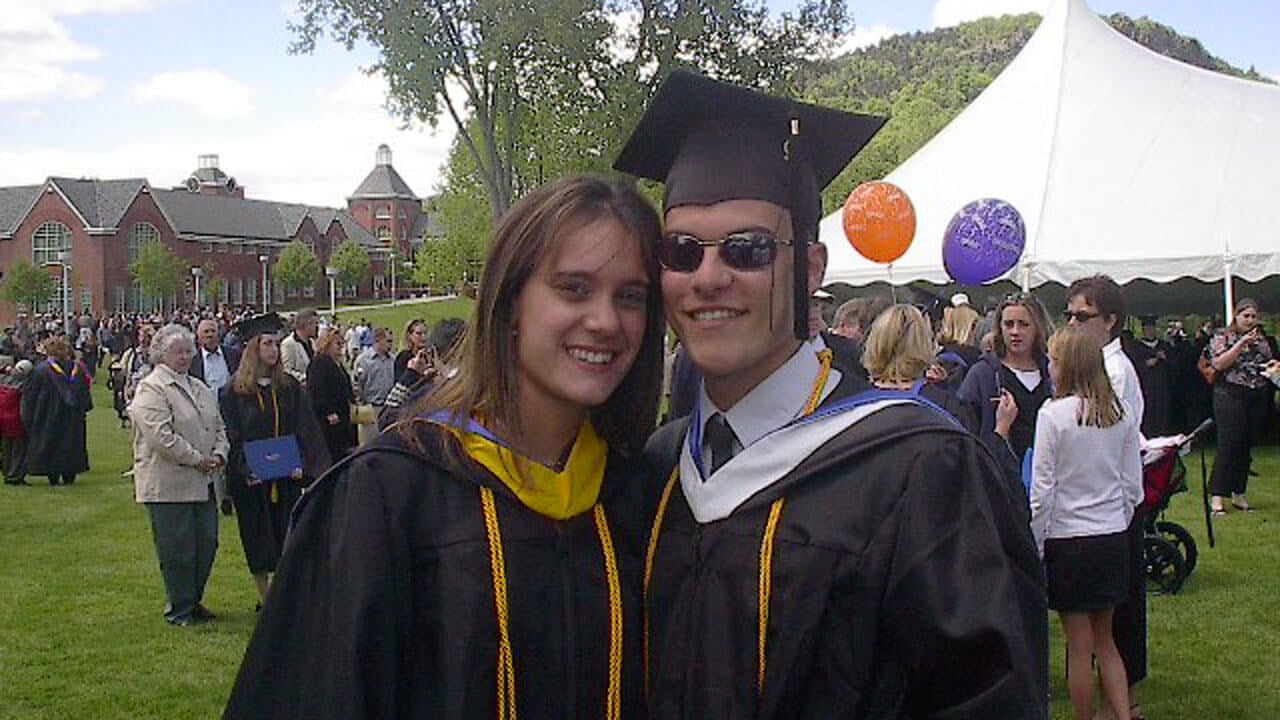 Alyssa and Jason Klein smiling in their caps and gowns at graduation