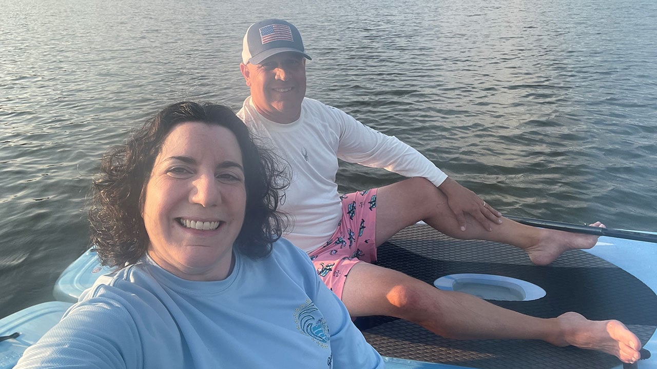 the howes pose for a selfie while canoeing