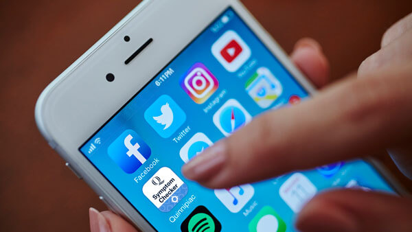 Person using a mobile device clicks the symptom checker app