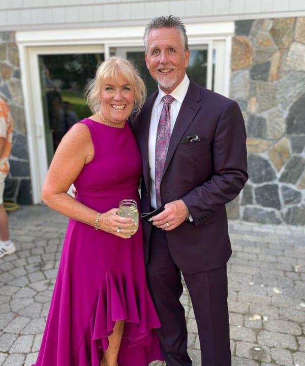 Tina and Tim Saler smiling while dressed in formal attire