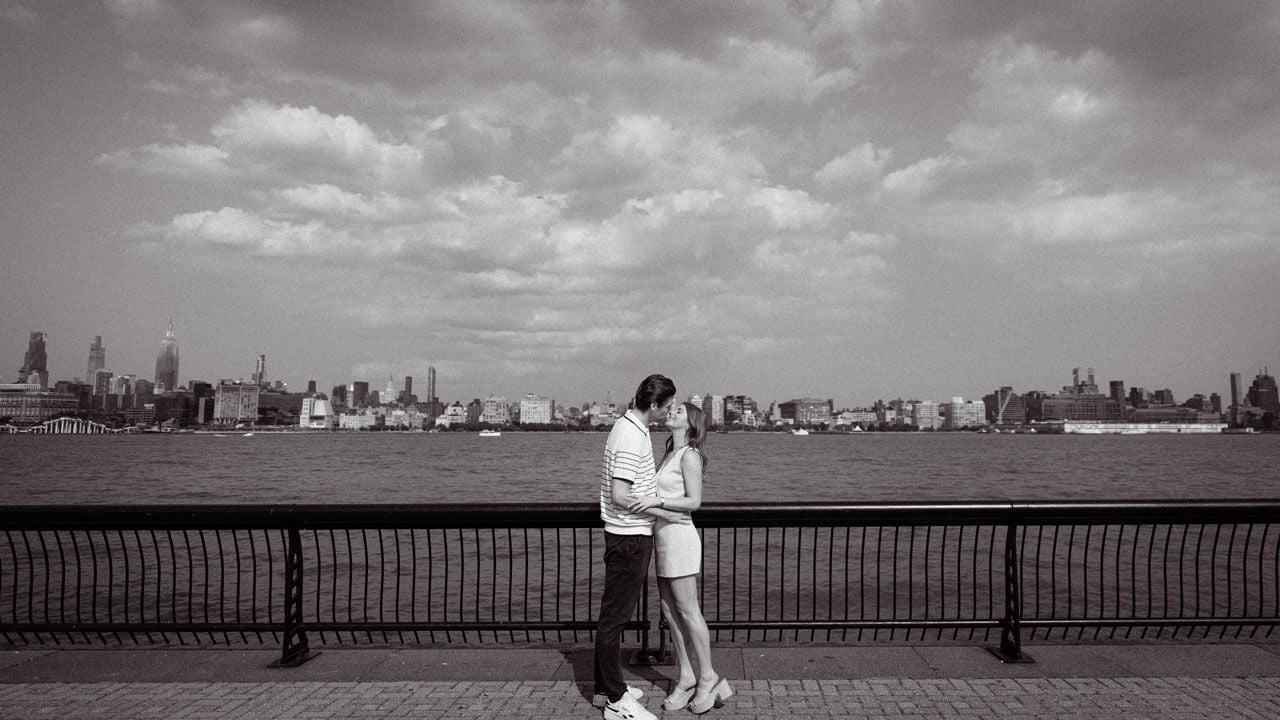 Olivia Schueller and Chris Dacey share a kiss in a black and white vintage inspired photo