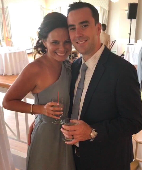 Mara and Joe Almada pose for a photo smiling in formal attire