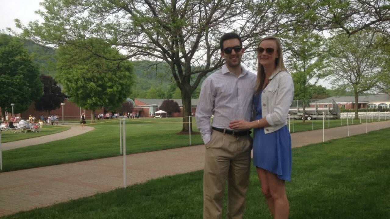 Bridget and Miles Adrian smile together while posing for a photo on the quad