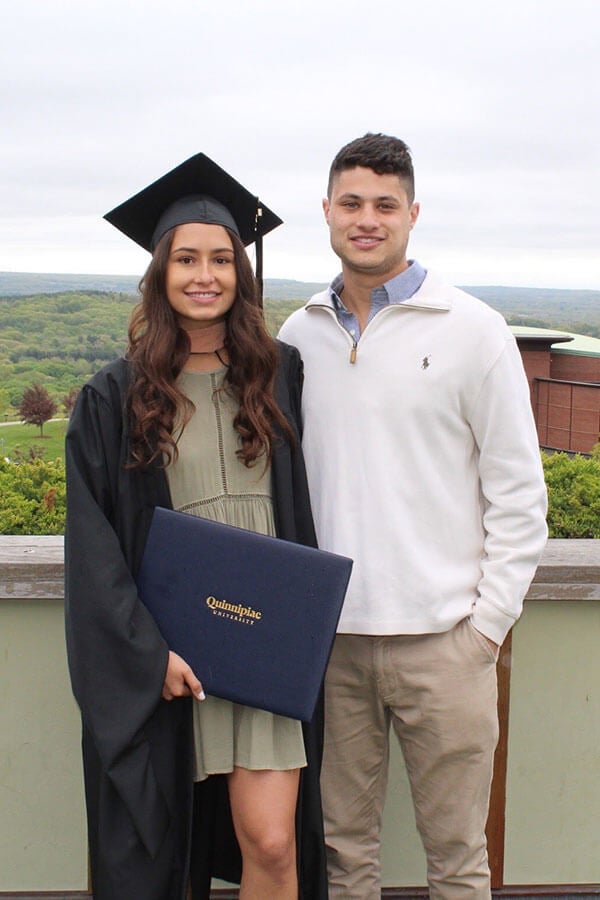 taylor parenti and matt coopersmith smile together at taylor's graduation