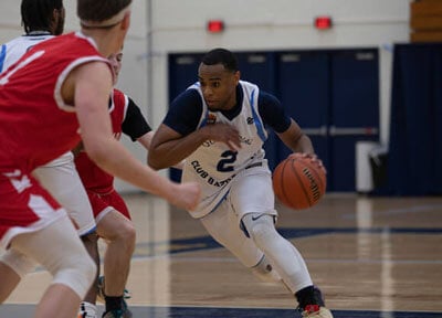 Men on basketball court passing basketball