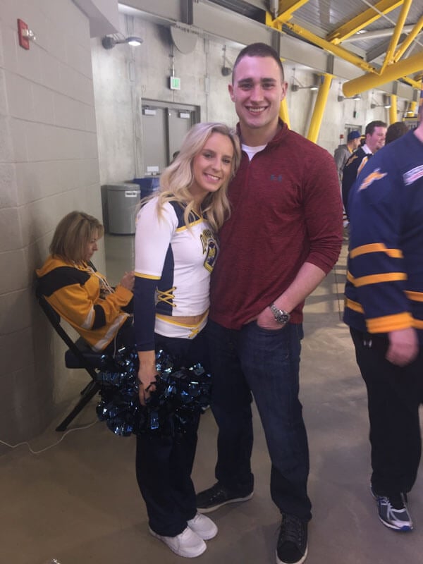 Gabrielle in her ice cat uniform with Joey at the rink.