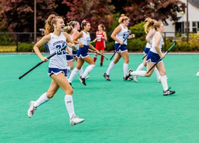 Group of girls playing field hockey