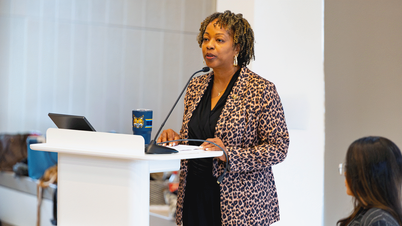Nadine Barnett talking at a podium