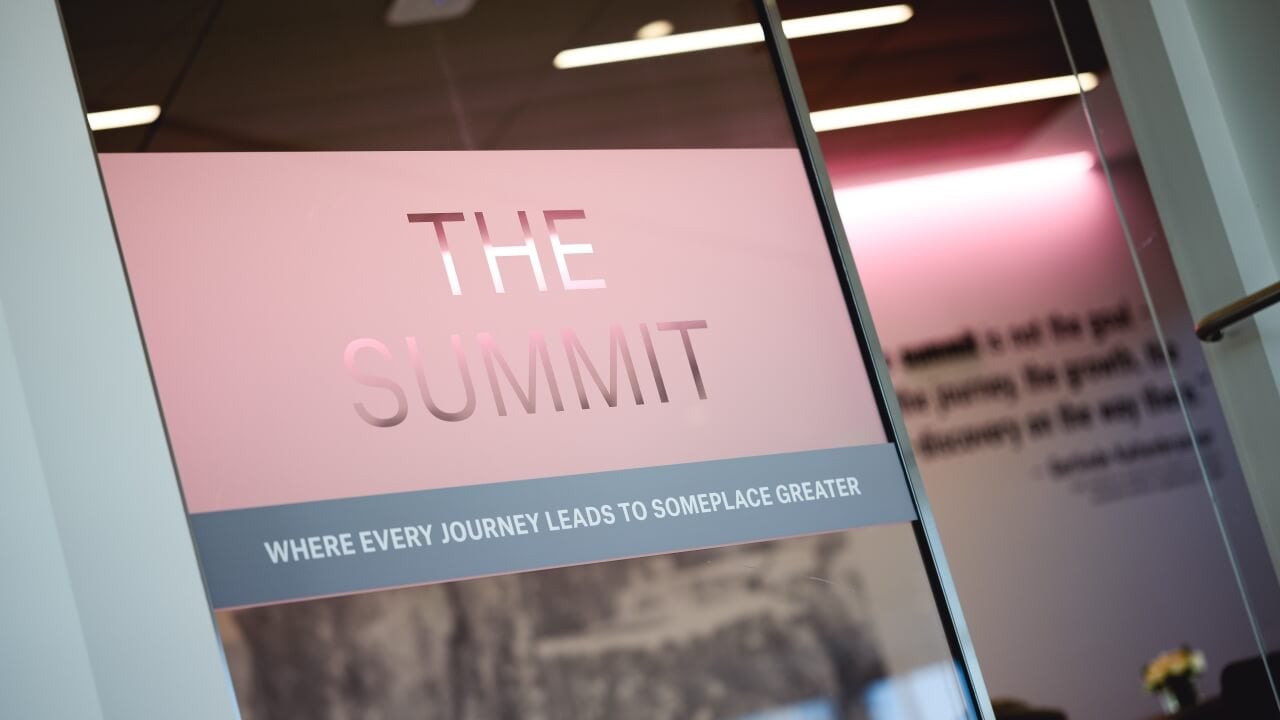 Text that reads The Summit on a frosted glass window
