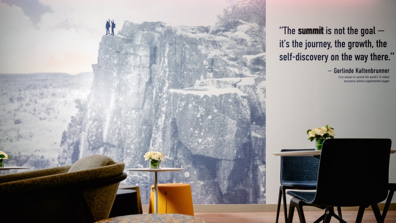 Wall décor in The Summit that showcases two people on top of a mountain