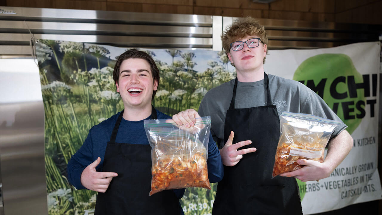 Students holding up homemade kimchi at RecWell
