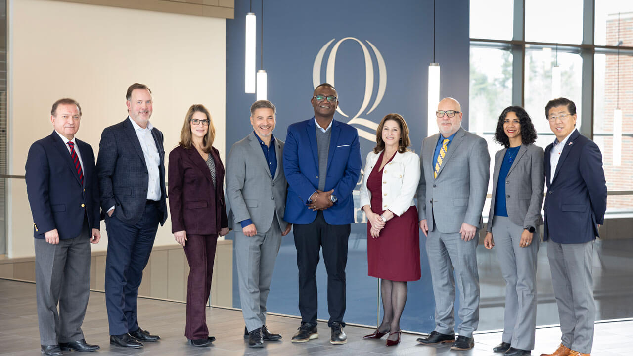 School of Business deans share a smile while standing together