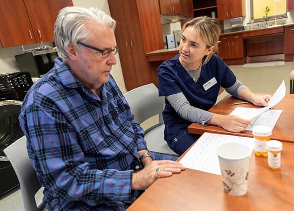 young woman OTD speaking with elderly man