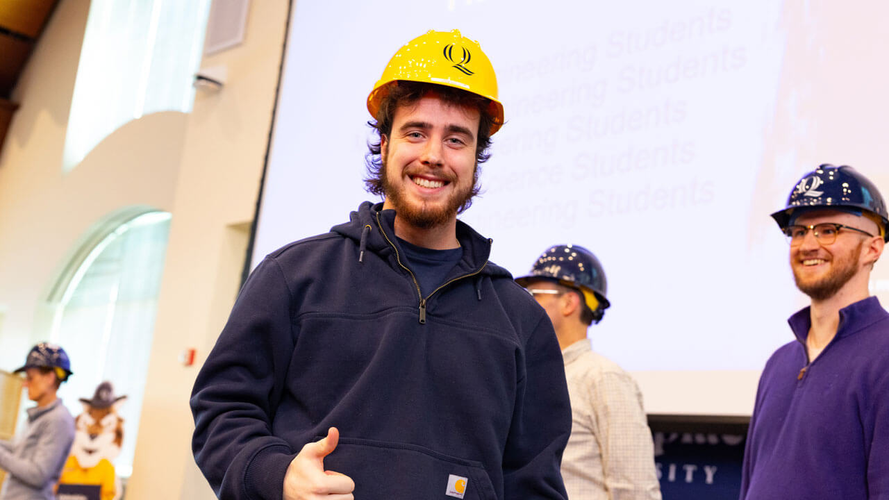 Student shows off their hard hat