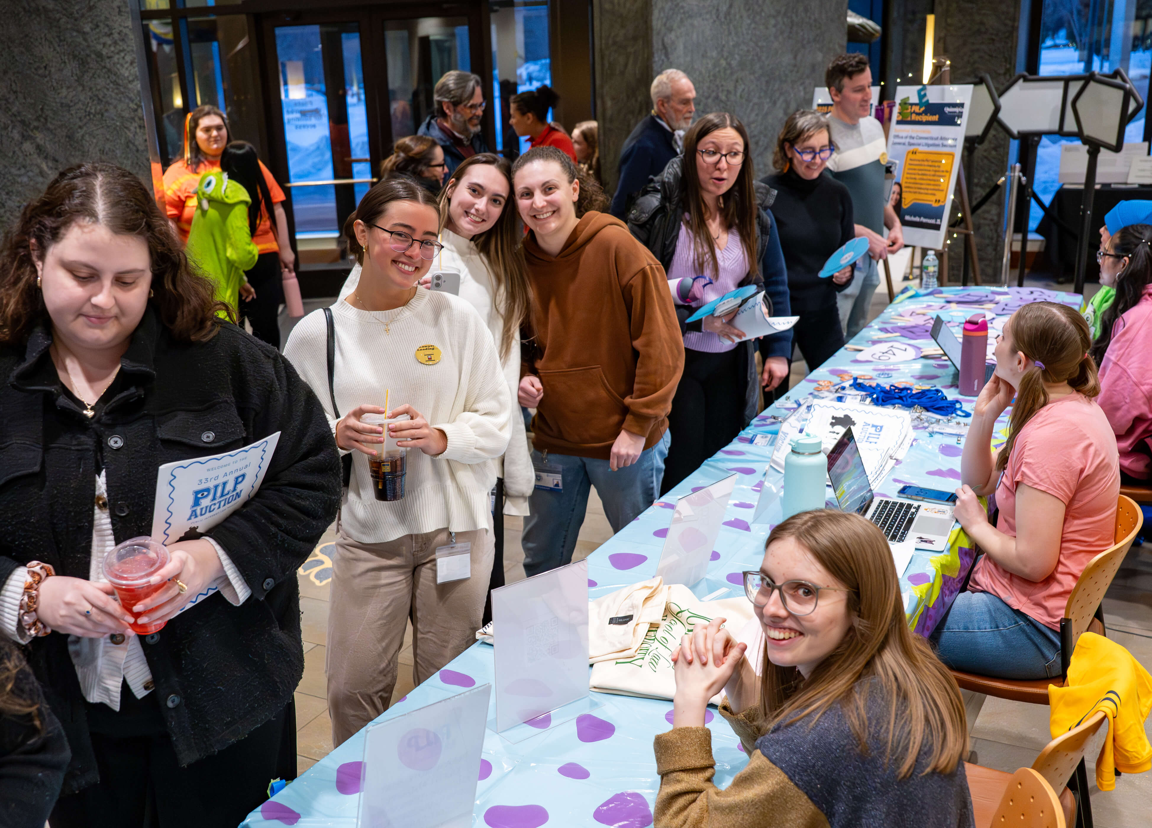 Students smile together at the PILP Auction