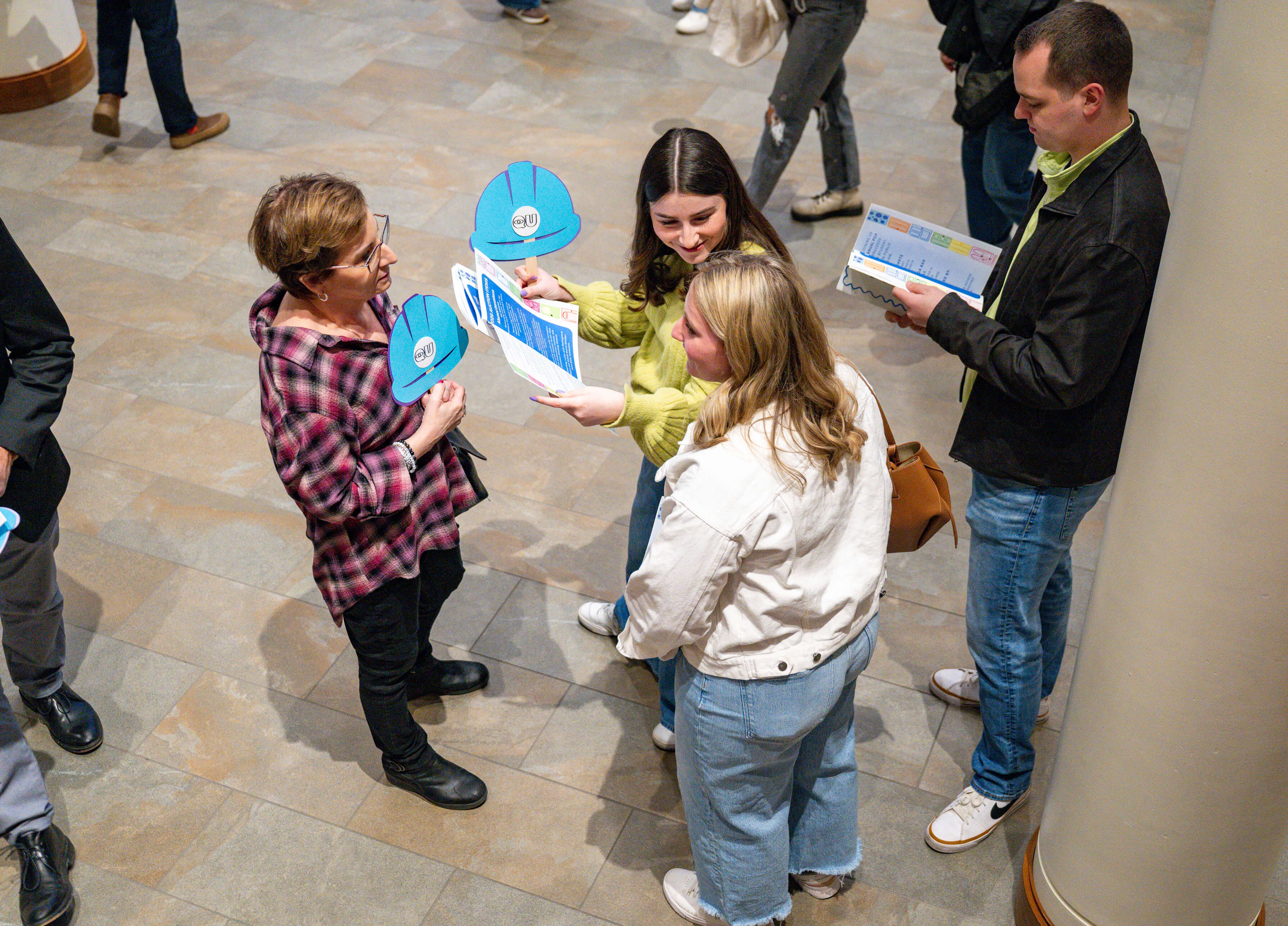 Three people chat at the PILP Auction