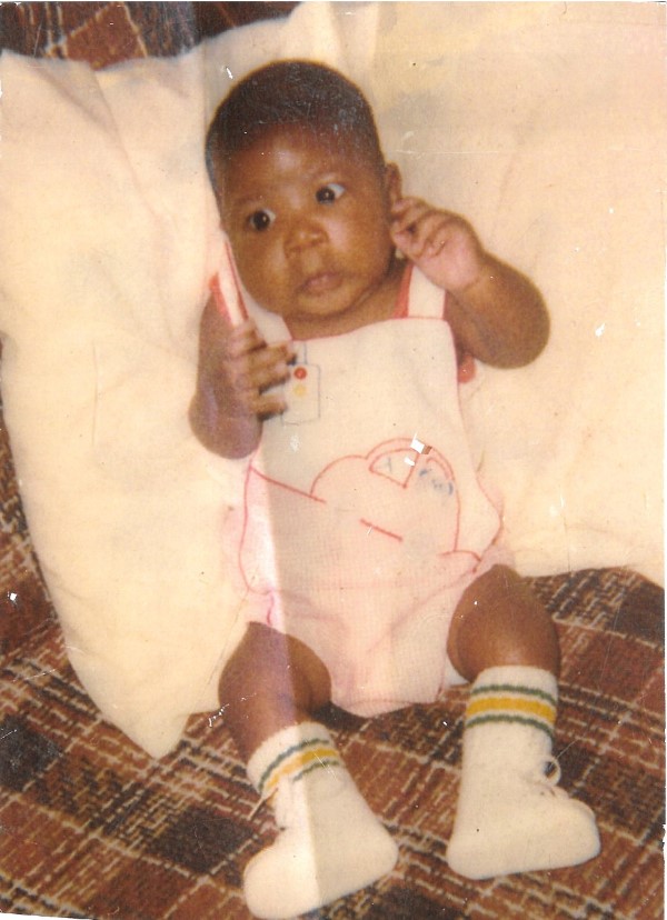 3 month old baby Walter Butler in white overalls with a car pattern