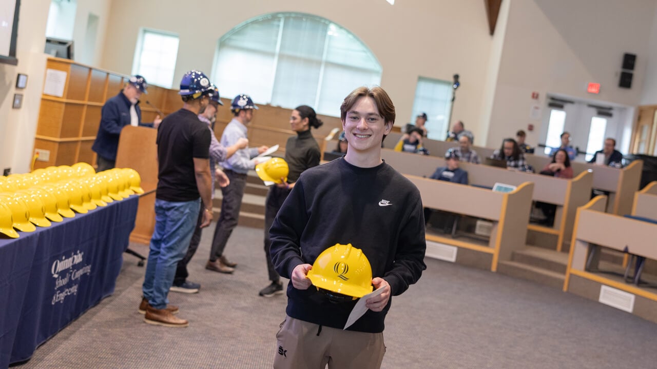 Individual holding a hard hat