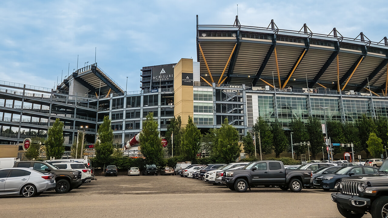 Stadium exterior view showing parking area.