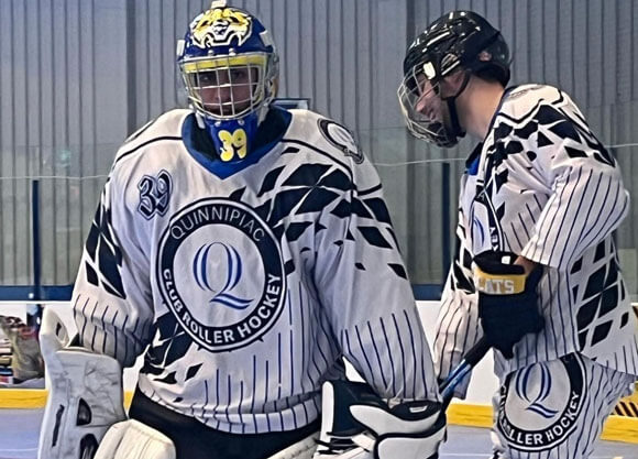 Two men talking in the roller hockey rink