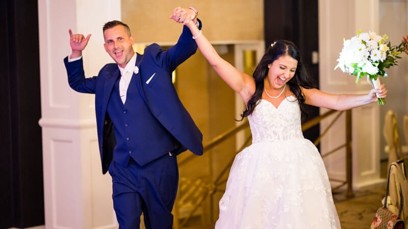 Couple entering wedding reception