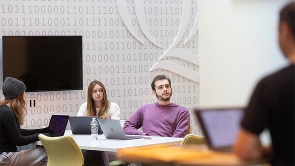 Students within the Center for Communications, Computing and Engineering sit at their desks and watch a professor.