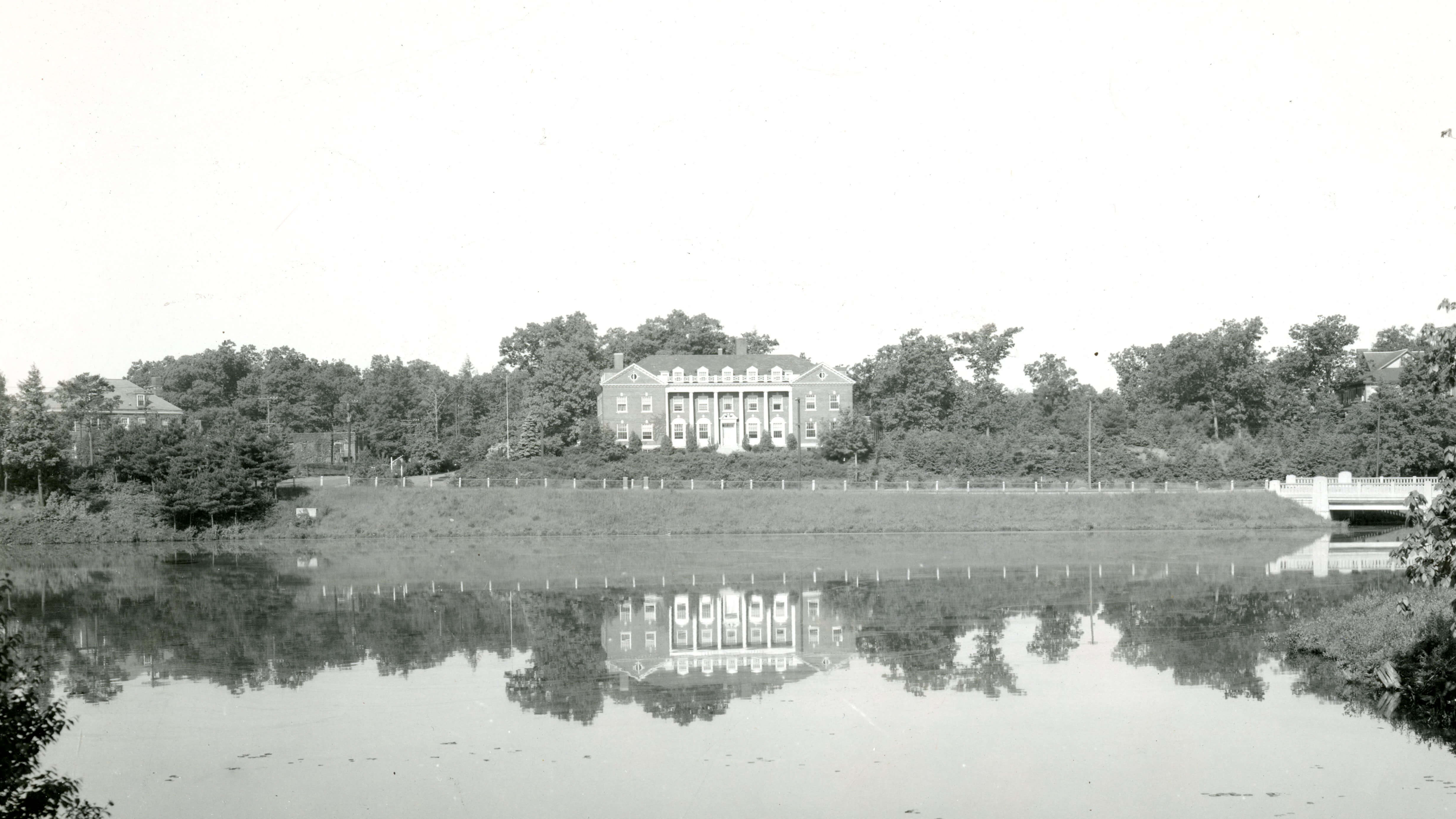 House over looking a body of water with a reflection