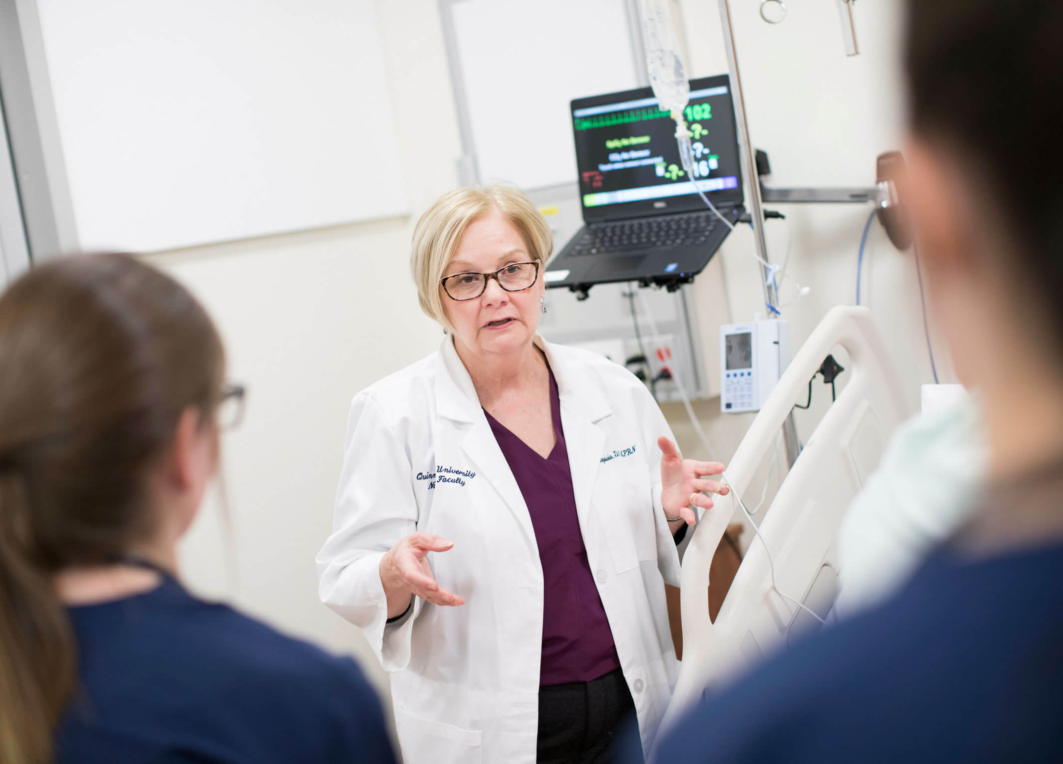 A School of Nursing professor works with students.