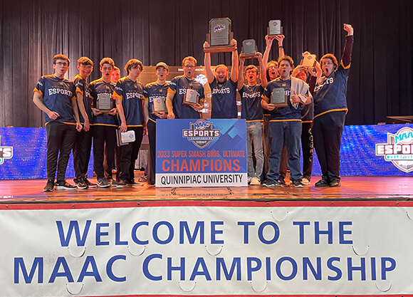 eSports team smiles with their trophy.