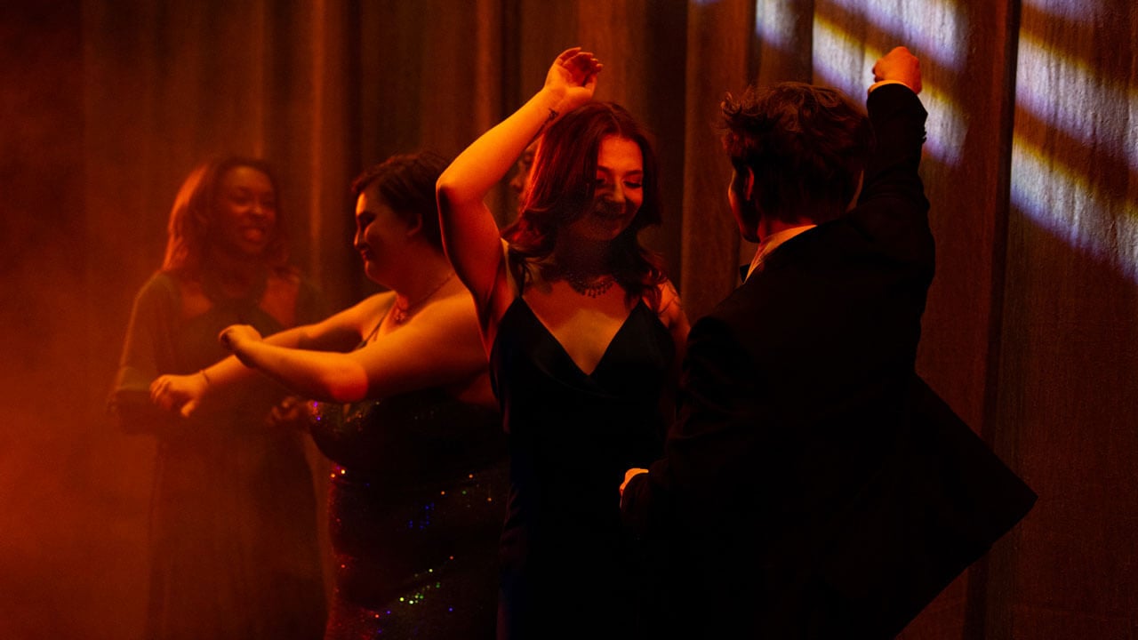 Students dancing in colorful lights