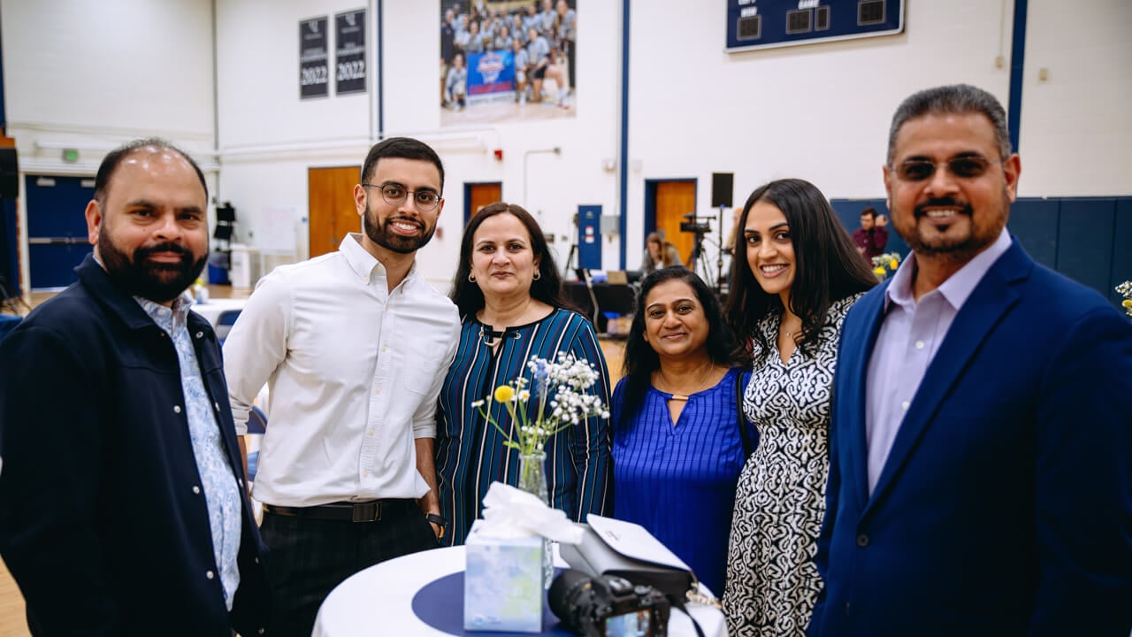 A medical student poses for a photo with her family during Match Day